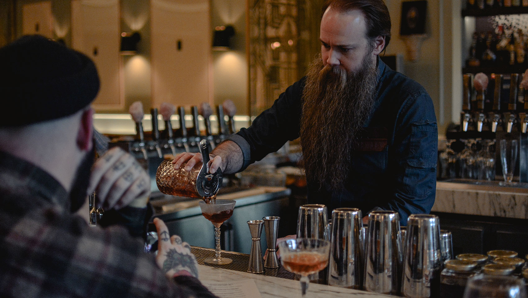 Bartender pouring a mixed drink at Kimpton Aertson for a guest