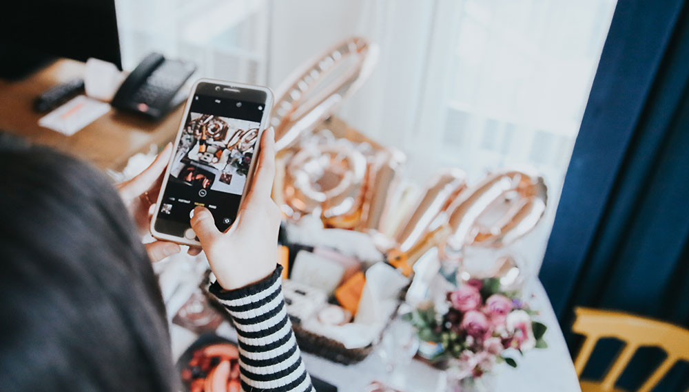 guest using a phone to photograph an amenity display at Kimpton Aertson