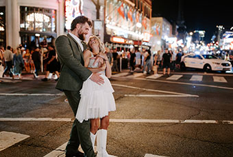 Couple on busy Nashville Street at night